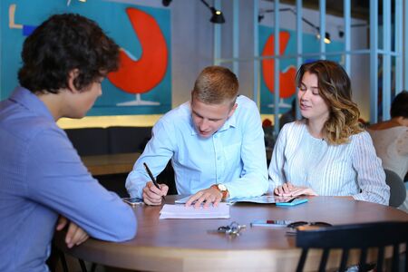 Young business rich couple buy an apartment, property, house, apartment, enter into a contract. Signs an agreement with the seller, Leaf catalog pagesの写真素材