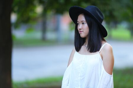 female hat nature summer sun sunset looks pleased. azitka woman black hair dancing around trees.の写真素材