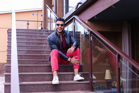 Modern stylish man, students gathered to spend time at restaurant and decided to have dinner, arranged meeting with girl and is waiting for her at entrance to restaurant, poses for catalog of mens clothing brand, advertises glasses. Guy Has Dark Hair and の写真素材