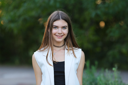 Woman with long hair and beautiful eyes on a green background shows the different human emotions. Lady portrays joy, lightness, ease, delight, happinessの写真素材