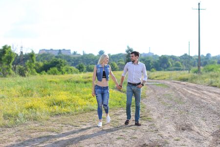 Young beautiful couple is embracing a man takes care of a woman happyの写真素材
