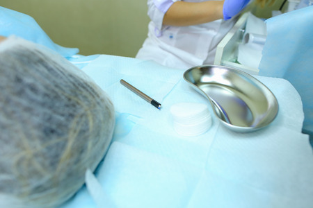 Hands of girls master for reconstruction of eyebrows, preparing for beginning of working day, disinfects and selects tools with which to work, changes or putting on gloves, conducts master class. Concept of mikrobleyding eyebrows micropigmentation proceduの写真素材