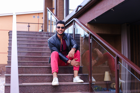 Modern stylish man, students gathered to spend time at restaurant and decided to have dinner, arranged meeting with girl and is waiting for her at entrance to restaurant, poses for catalog of mens clothing brand, advertises glasses. Guy Has Dark Hair and の写真素材