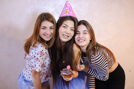 Cheerful and beautiful female friends laugh and smileの写真素材