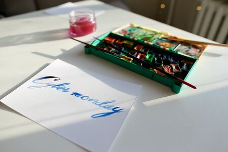Bright inscription for sale, Cyber Monday written in blue watercolor paints and brush