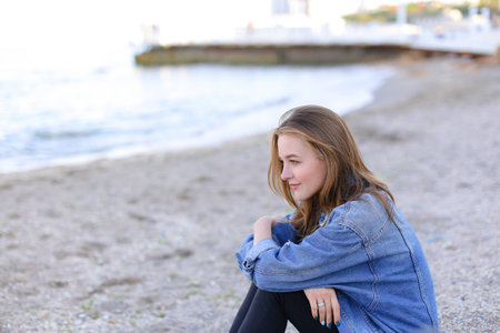 Shooting  portrait of charming woman who poses on camera with slightly mysterious smileの写真素材