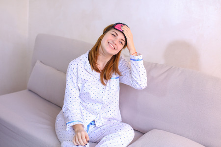 Lovely sleepy girl woke up with smile on face and stretchedの写真素材