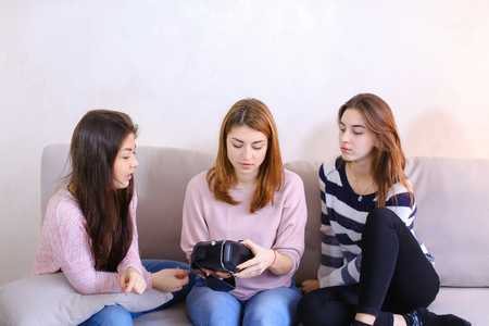 Attractive girls hold modern devicesの写真素材