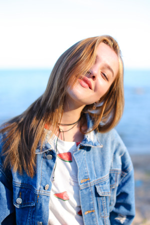 Lovely girl poses positively on camera in perfect mood, smiles and laughs sweetlyの写真素材