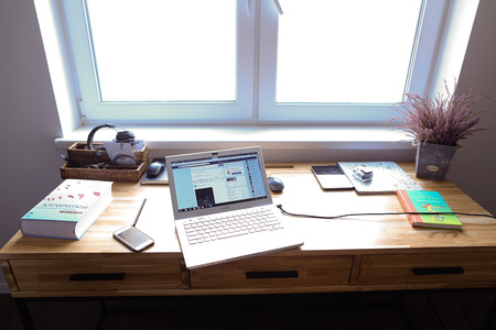 Interior situation and arrangement of office in bright and spacious room. In room there wooden...