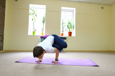 Beautiful girl with dark hair engaged in fitness studioの写真素材