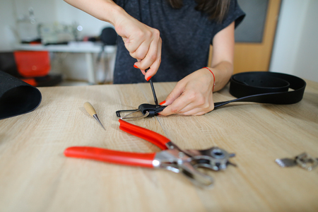 Craftswoman with red nails and braceletの写真素材