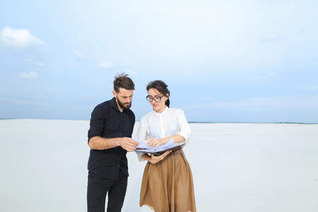 entrepreneurs create project of beach arrangement, colleagues come to location to discuss...