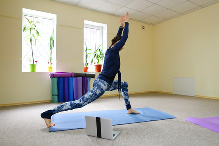 Beautiful girl stretches back muscles. Concept of physical fitness, keep good physical form.の写真素材
