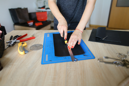 Female showing how to make stylish leather purse, blogger interested in handmade and decided to...