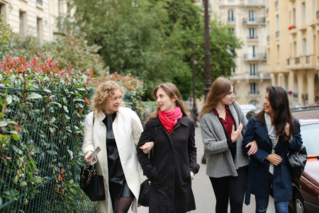 Half Chinese female student telling about studying abroad in   with close up face. Concept of giving interview about educational exchange programs. Beautiful girl with black hair speaking outside.の写真素材