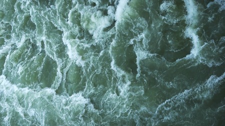 Levee elongated naturally occurring ridge or artificially constructed fill or wall, which regulates water levels. Water has small waves. Concept of contraction for save life water level.の写真素材