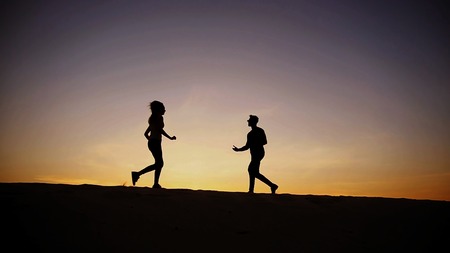 Girl runs to meet beloved boy, who runs towards her, lovers on move taking up arms and circling each...