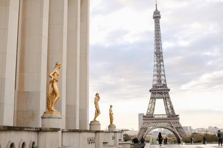 Square of Trocadero and gilded statues in Eiffel Tower backgound, Paris. Concept of French landmarks and visiting France.のeditorial素材