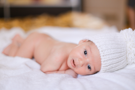 Little cute baby lying on white blanket naked. Concept of kids and babies.の写真素材