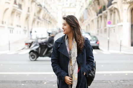 Asian young girl standing in street background, walking after classes. Concept of international students and strolling in city.の写真素材