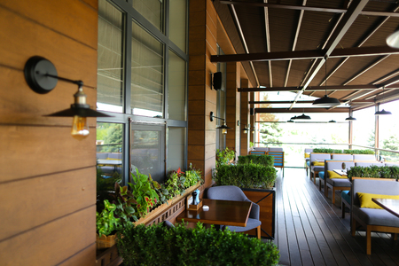 Close up electrolier and edison lamp in cafe background, room plants. Concept of interior design and snug.の写真素材