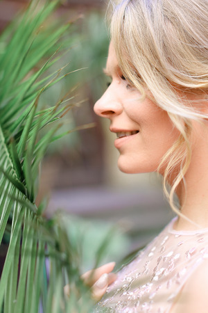Closeup portrait of caucasian fiancee and cedar wood. Concept of bridal makeup and hairdoの写真素材