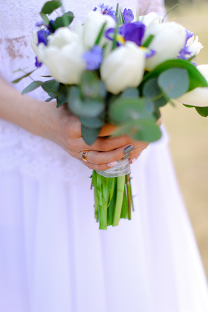 Closeup fiancee keeping bouquet of flowers. Concept of floristic art and wedding.の写真素材