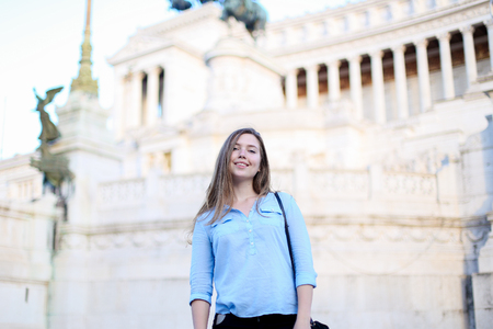 Young female tourist standing near Altare della Patria in Rome. Concept of traveling to Italy and last minute tours.の写真素材