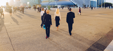 Employees of financial organization walking in   with tablet and document cases in  . Concept of prosperous team members and time management. Successful people wears business clothes.の写真素材