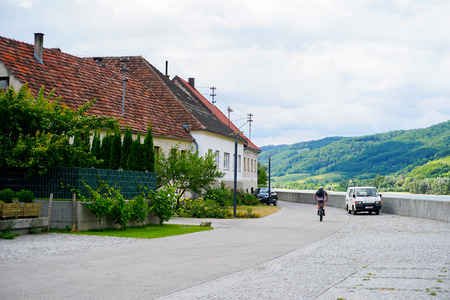 Houses in Austria on Danube beach with red tiled roofs. Concept of european rural places and countyside nature, summer vacations in village.のeditorial素材