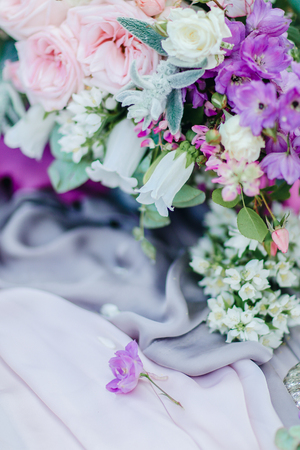 Blurry image with focus on little violet flower. Concept of floristic art and wedding decorations.の写真素材