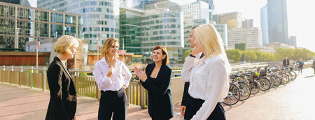 Financial team employees speaking with boss in La Defense Paris. Concept of decision making and business meeting. Responsible people planning work outside.の写真素材
