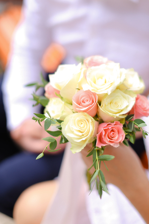 Close up nice bouquet of white and pink flowers in bride hands. Concept of weddng, bridal decorations and floristic art.の写真素材