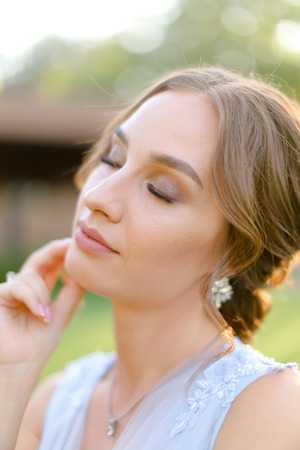 Close up portrait of caucasian nice charming bride outside. Concept of beauty and bridal makeup.の写真素材