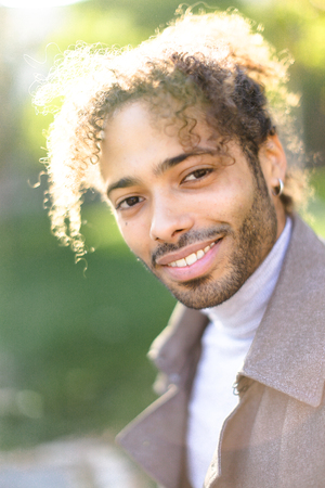 Portrait of afro american smiling boy with curly hair. Concept of male person.