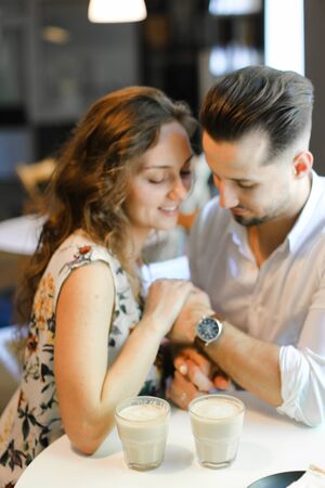 Soft focus photo of happy smiling couple sitting at cafe. Concept of dating at restaurant and pleasent moments.の写真素材