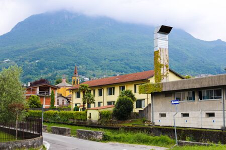Italian Mandello del Lario houses with Alps mountains in background. Concept of counrtyside and village architecture.の写真素材