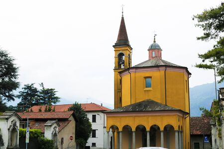 Yellow italian church exterior with columns in Mandello del Lario. Concept of architecture and traveling to Europe.の写真素材