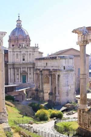 Great ruins of Roman Forum and church in Rome. Concept of historical landmarks, sightseeing and last minute tours to antique Italy.の写真素材