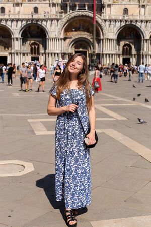 Woman standing on piazza San Marco in Venice, Italy. Concept of tourism and tours to Venetsian landmarks.の写真素材