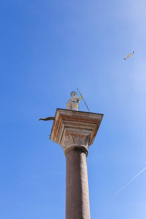 Column with sculpture in Venice, Italy. Concept of antique architecture.の写真素材