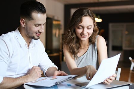 Young caucasian businesswoman working documents and talking with boss. Concept fo business and job.の写真素材