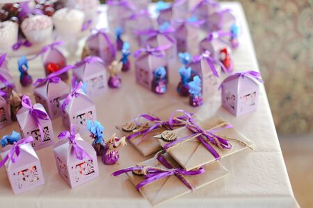 Nice violet decorations for birthday party, sweets and envelopes. Concept of congratulations and decor.の写真素材