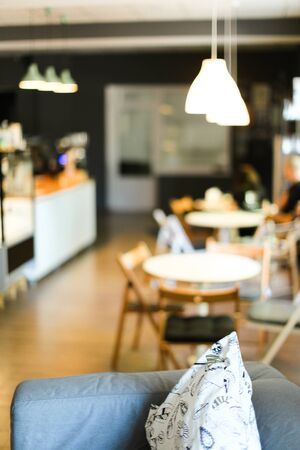 Soft focus photo of cafe with sofa and pillows. Concept of interior backround.の写真素材