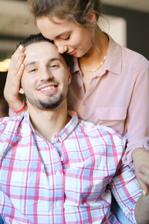 Caucasian female person kissing man wearing shirt. Concept of spending time together, love and feelings.の写真素材