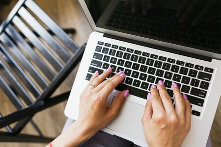 Close up hands texting on laptop keyboard. Concept of typing speed and modern technology.の写真素材