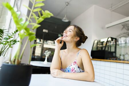 Young gorgeous woman resting at cafe and resting. Concept of photo session at restaurant.の写真素材