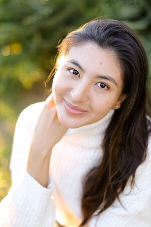 Portrait of chinese woman sitting outdoors. Concept of asian female person and beauty.の写真素材