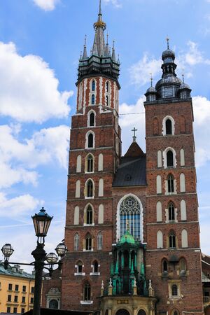 St. Mary's Basilica exterior in Main Square in Krakow, Poland. Concept of traveling to Europe and famous brick gothic church, architecture elements.の写真素材